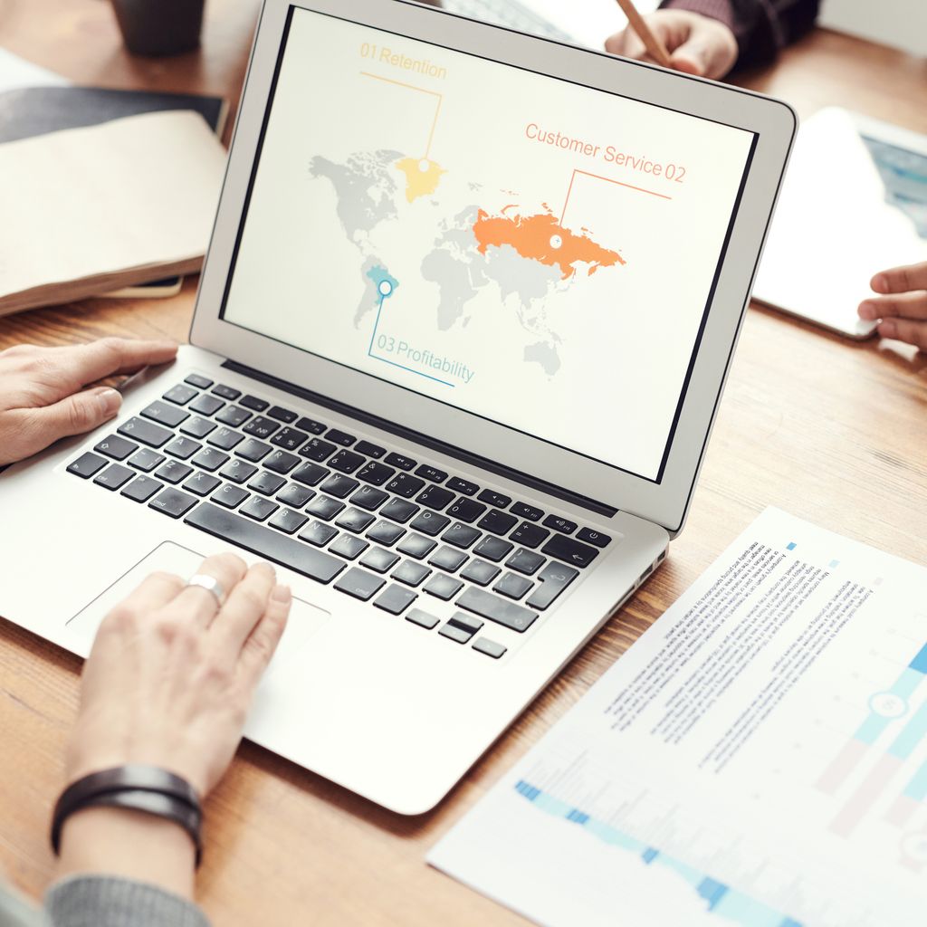 A team reviewing product data on a laptop