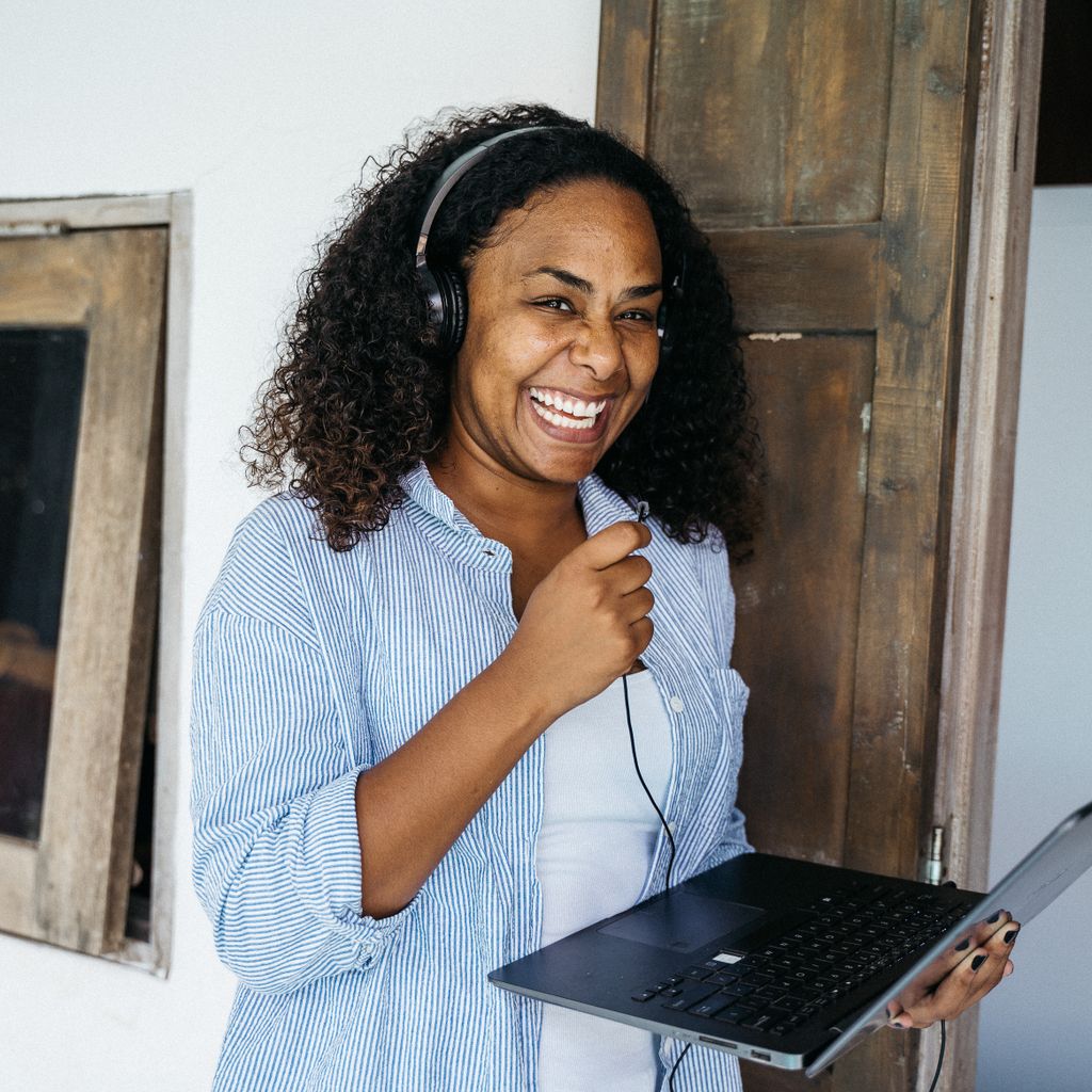A support specialist with a headset working on a laptop