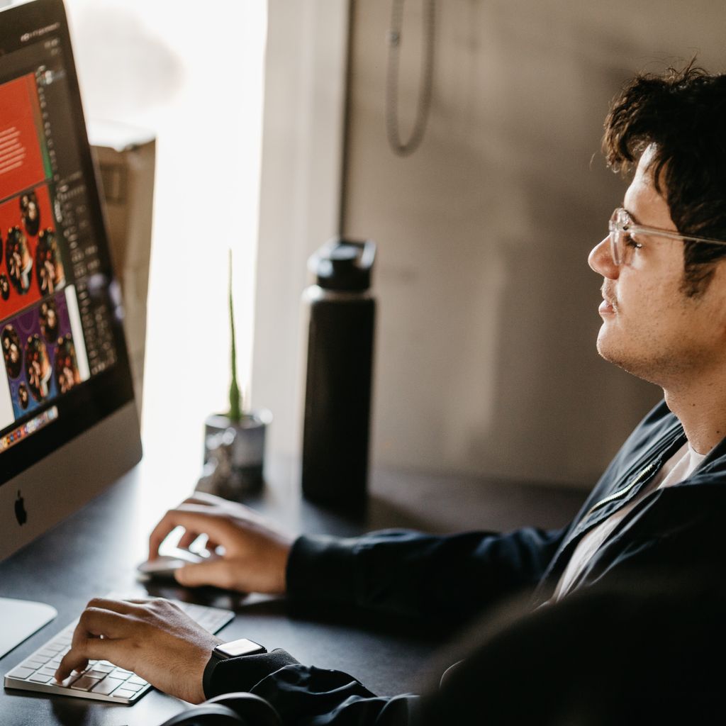 A developer working on a website layout at his desk
