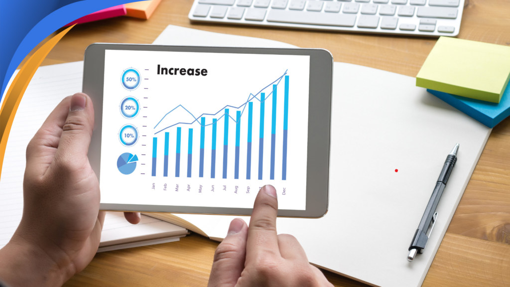 Tablet showing a rising revenue chart held by a revenue operations manager