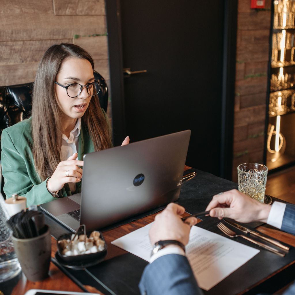 Two colleagues reviewing a contract together at a meeting table