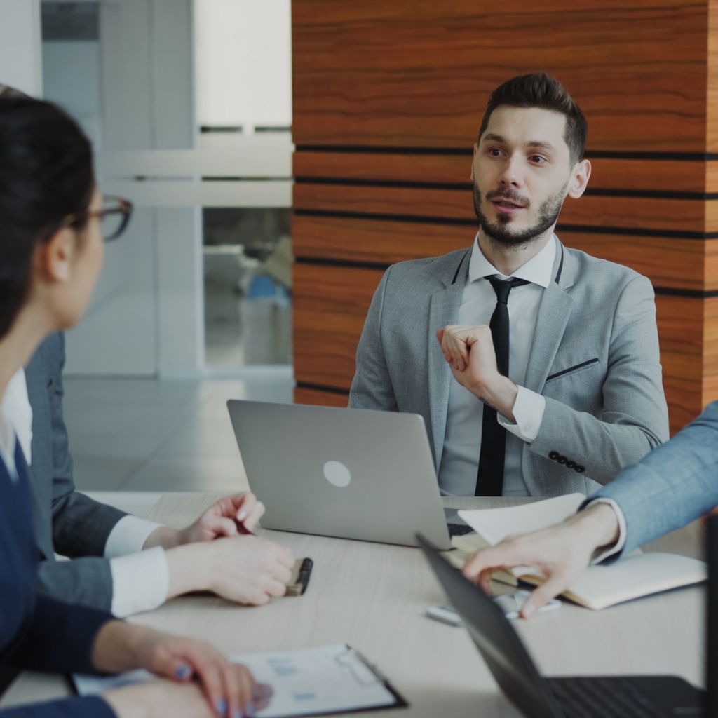 A professional joining a team discussion at a meeting table