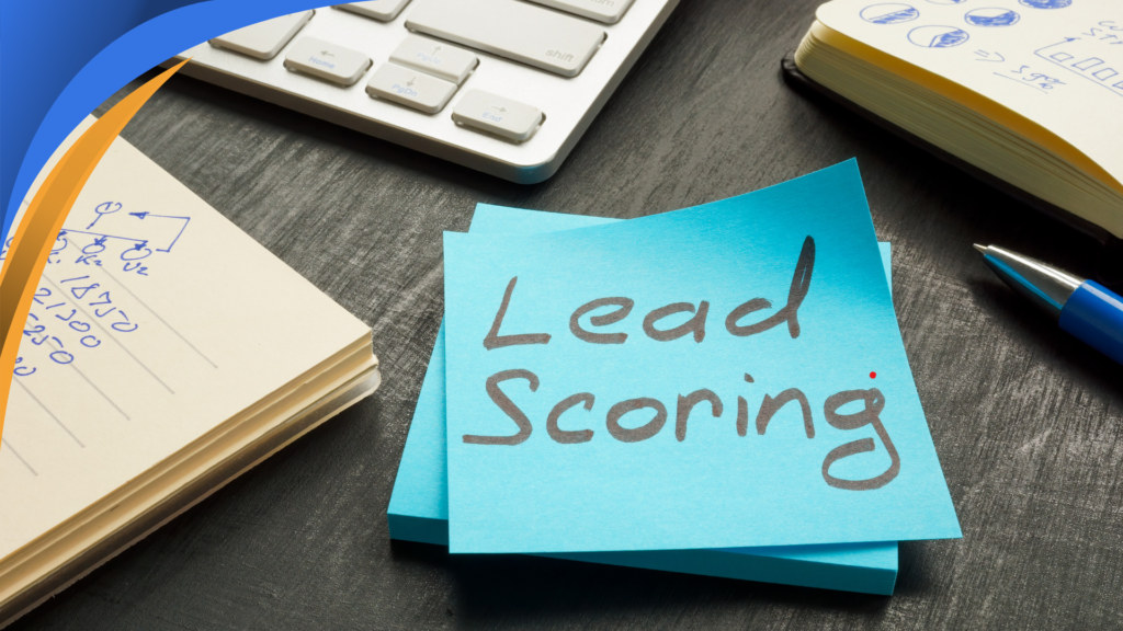 Sticky note reading Lead Scoring on a desk next to a keyboard