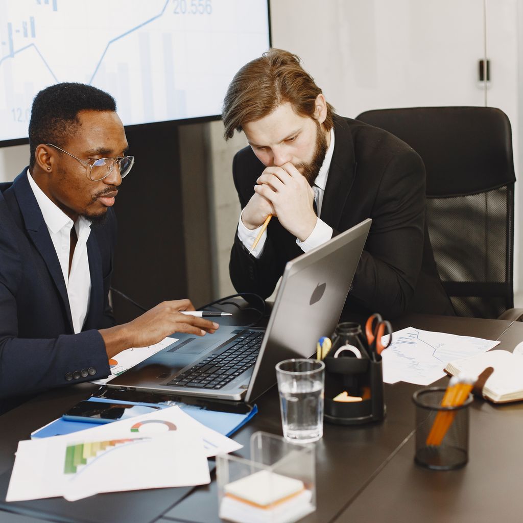 Two colleagues reviewing campaign data on a laptop