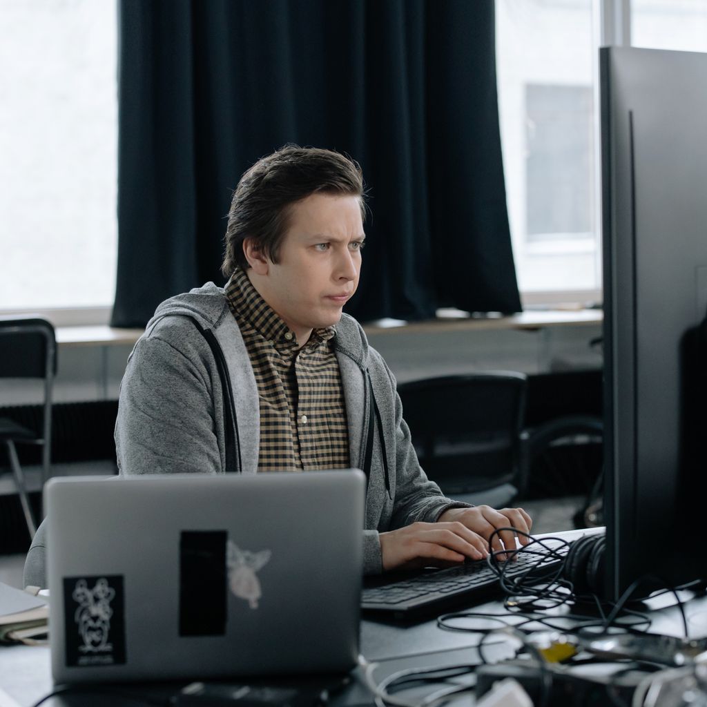 An engineer working at a laptop in an office
