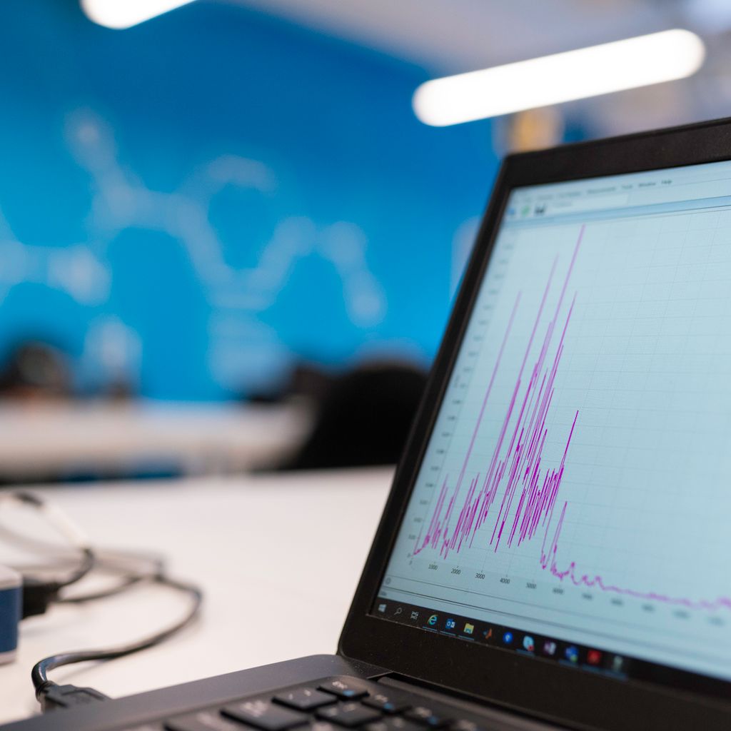 A laptop showing a data chart in an office