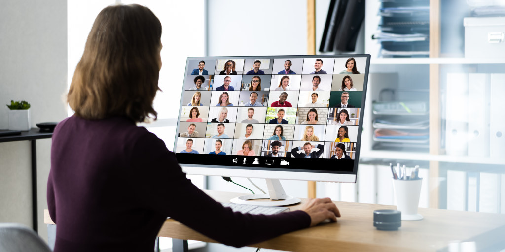 Hiring manager on a video call with a grid of remote candidates