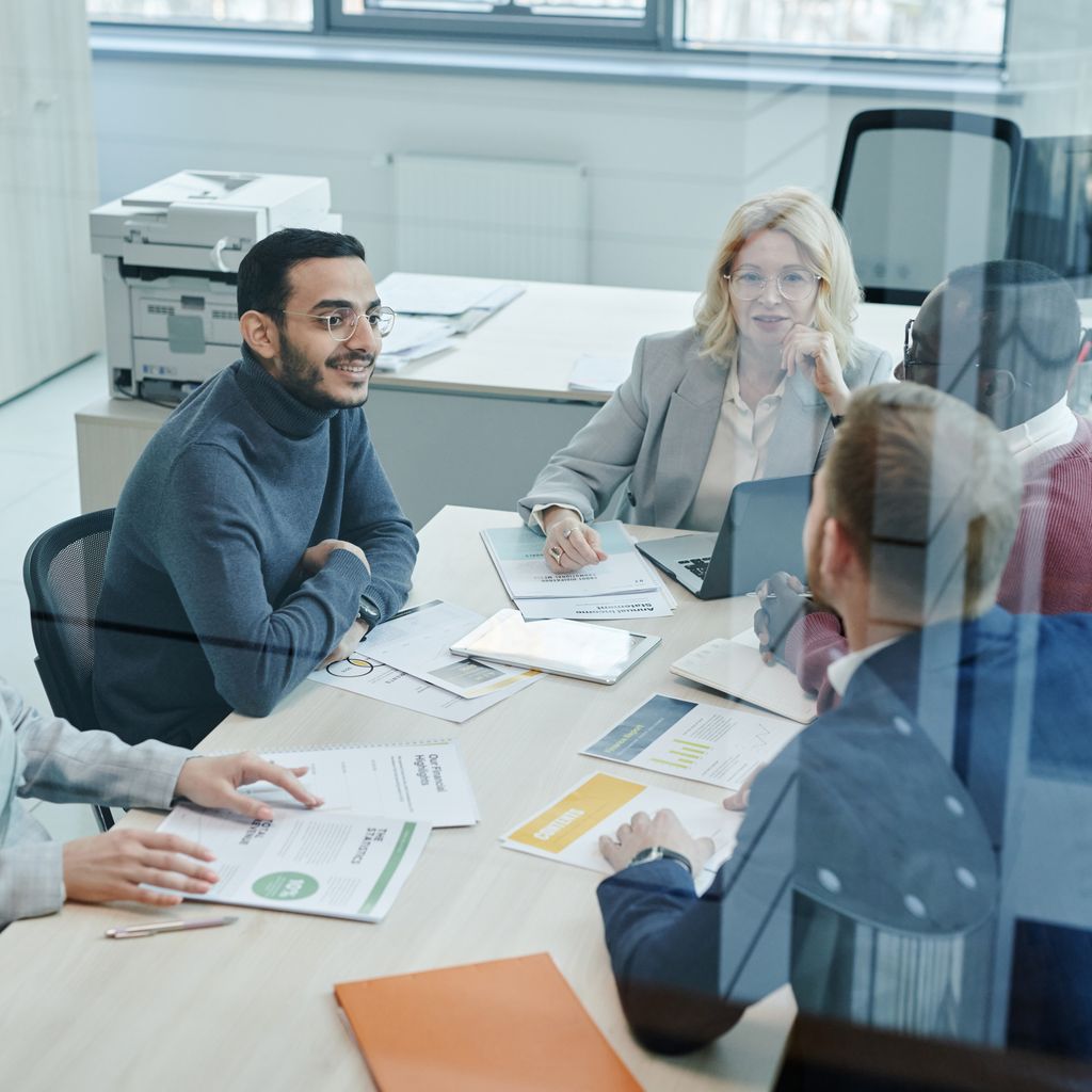 A marketing team reviewing a campaign plan around a meeting table