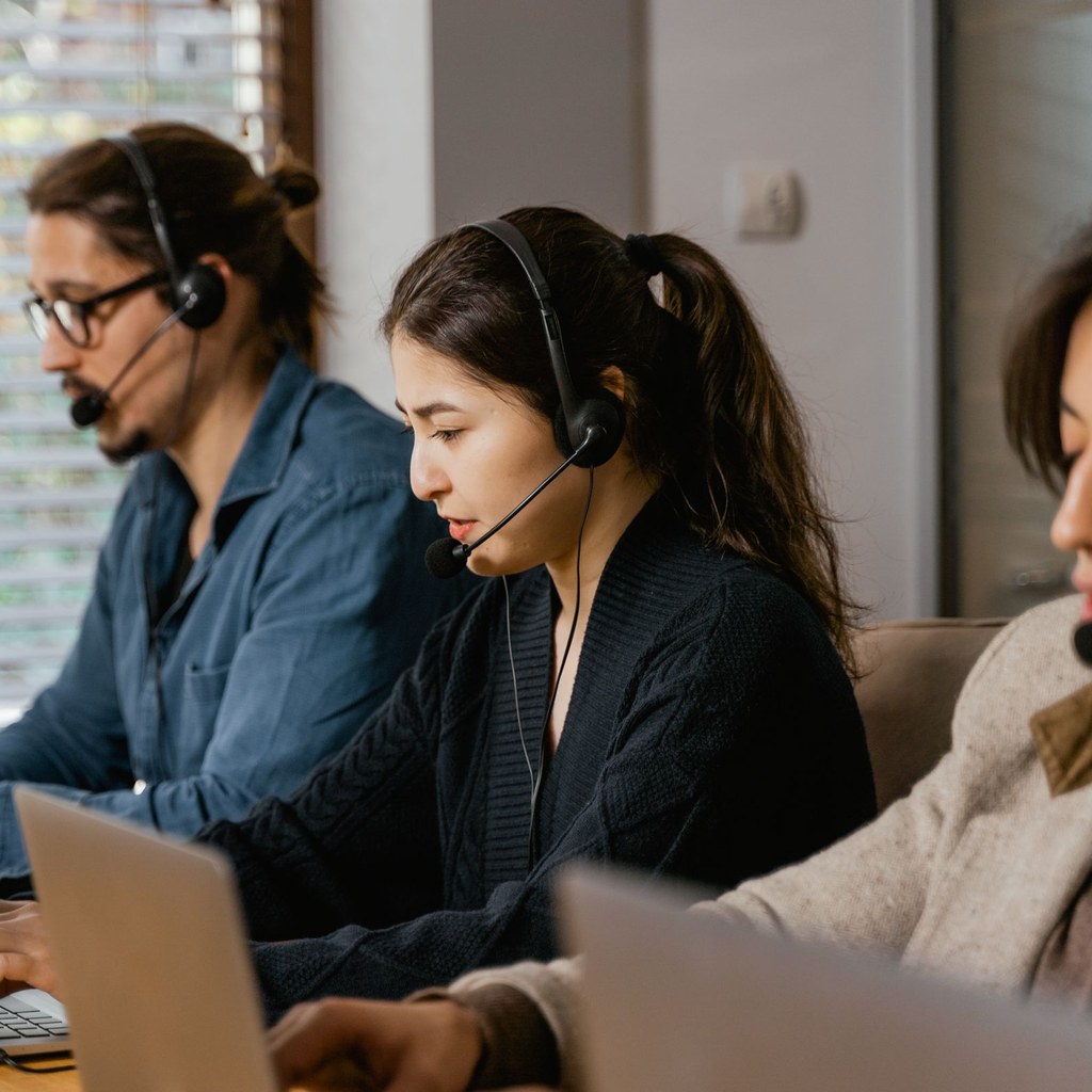 Outbound team on headsets working calls from their laptops