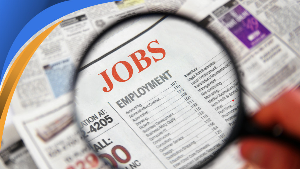 Magnifying glass over the employment section of a newspaper